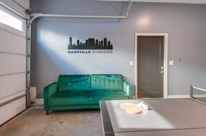Enjoy luxury and fun in Nashville! This chic space, with a cozy emerald green sofa, is perfect for relaxing after exploring downtown and hosting game nights. Your ideal home base for an unforgettable adventure in Music City!