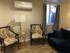 A comfortable seating area and heat/ac unit and egress window