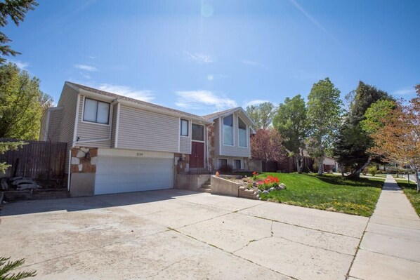 Behold the stunning view of our house, complete with a spacious garage that adds both functionality and aesthetic appeal to the overall design. This captivating scene showcases the harmonious blend of architectural elements, beautiful landscaping.