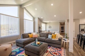 Experience seamless living in our combined living room and kitchen. This open-concept space fosters a sense of togetherness, allowing you to relax on the comfortable couch while staying connected to the heart of the home.