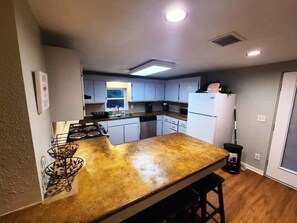 Spacious kitchen fully equipped and ready for your next vacay.