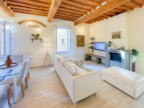 Living Room with sectional sofa, Smart TV, Fireplace and a modern Puff 