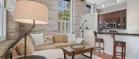 Granite stone walls from floor to ceiling add charm in this modern apartment.