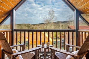 Enclosed balcony with bedroom access, including two adirondack chairs