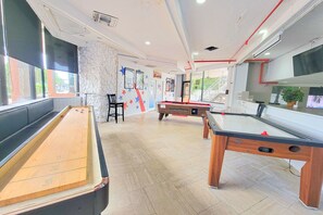 Game Room with Table Shuffleboard, Ping Pong, Billiards and more.