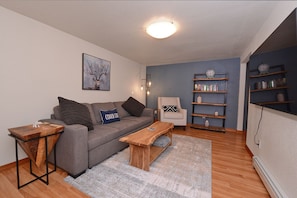 Living room with pull out sofa. 65 inch smart tv with streaming services.