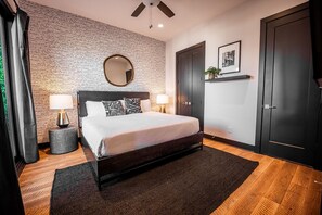Master bedroom with king size bed, designer furnishings, access to patio, 75 in flat screen TV and en-suite bathroom.