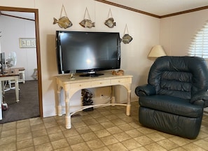 TV and recliner in living room 