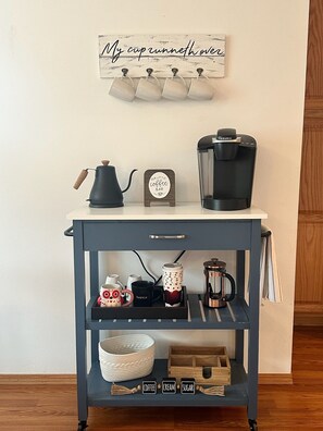 Coffee bar including coffee, tea, kettle, French press and Keurig.