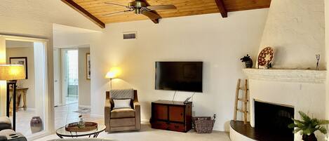 Living room with vaulted ceilings and electric fireplace 