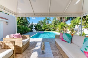 With entrance through the Florida room to the perfect outdoor oasis. Relax under the covered patio and outdoor furniture. Outdoor dining table for 8. Pool loungers and BBQ grill. The stunning large pool is heated (daily pool heater fee is charged).