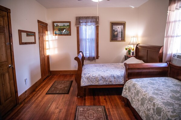 Private room featuring a queen sized bed, twin daybed and twin trundle. 