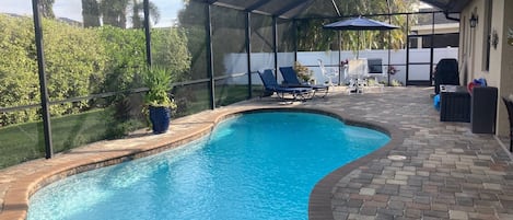 Pool area, table & chairs, lounges