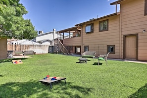 Large, fenced back yard with outdoor games and seating