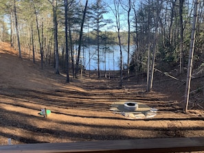 Back yard view of fire pit and lake