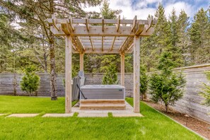 7 person Hot Spring hot tub, under a cedar pergola with lighting 