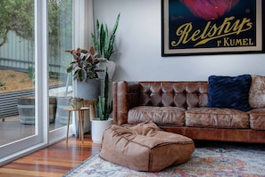 Sunroom with access to the back deck. Perhaps take a nap on this couch..