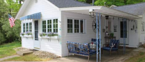 Front view of the Little White Cottage.  Entrance to the cottage from the porch.