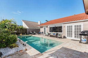 Lanai/Pool area featuring plenty of outdoor seating, hammock, and BBQ gas grill.