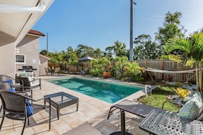 Lanai side view of pool and back yard landscape.