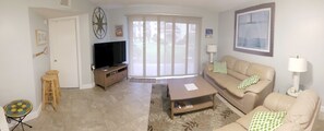 Spacious Living Room with UHDTV, leather sofas. Master bedroom door on left side