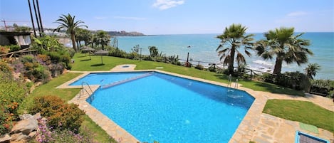 One of the swimming pools surrounded by gardens in this community by the beach