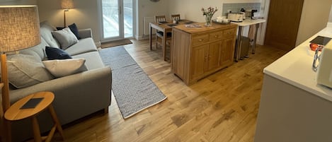 Open plan living with solid oak flooring & door to private enclosed patio garden