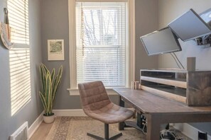 The private sun-filled office features dual computer screens that can connect to a laptop