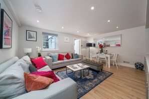 Create a sophisticated and inviting living area with our light gray sofa, accompanied by a stylish gray ottoman bench and a small white center table. Together, this ensemble creates a harmonious and modern ambiance, perfect for socializing.