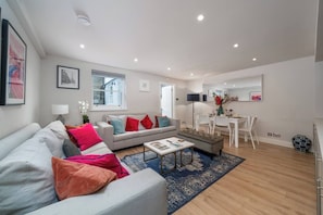 Create a sophisticated and inviting living area with our light gray sofa, accompanied by a stylish gray ottoman bench and a small white center table. Together, this ensemble creates a harmonious and modern ambiance, perfect for socializing.