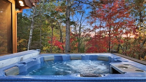 Relax in the hot tub with spectacular lake and mountain views