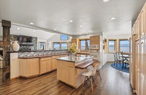Main level kitchen is open to the livingroom, dining room, bar/counter seats