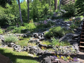 Terraced flower garden displays all kinds of flowers and succulents. 