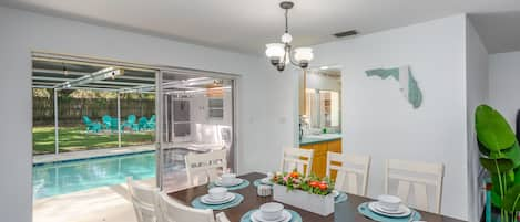 The dining room also has direct views of the swimming pool and back yard. 