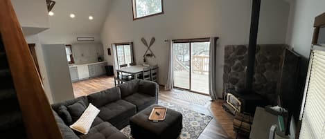 Double glass patio doors brings in all the views of the wooded lakeside yard. 