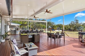 COVERED OUTDOOR DECK WITH POOL ACCESS AND VIEWS OF PLAYGROUND 
