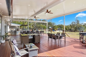 COVERED OUTDOOR DECK WITH POOL ACCESS AND VIEWS OF PLAYGROUND 