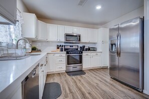 Fully stocked kitchen with stainless steel appliances