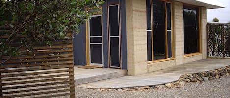 Rammed Earth walls and repurposed materials make this guest house unique