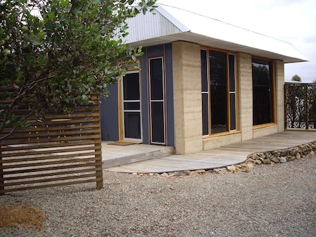 Rammed Earth walls and repurposed materials make this guest house unique