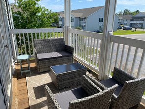 Relax and enjoy the view from your private balcony, furnished with comfortable seating for your leisure.