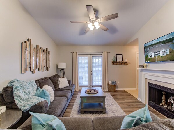 The classic French doors accentuate the charm and warmth of the living room as they invite you to step out onto the private balcony.