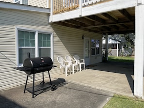 Outdoor area with covered sitting area and charcoal grill