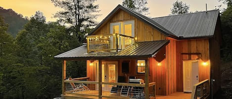 This photo shows the cabin's covered deck and master bedroom balcony.