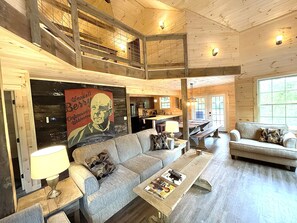 This view shows the upper balcony that overlooks the valuted ceiling livin room.