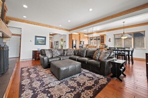The open-concept living space, complete with a dining area, facilitates effortless conversation with family and friends.