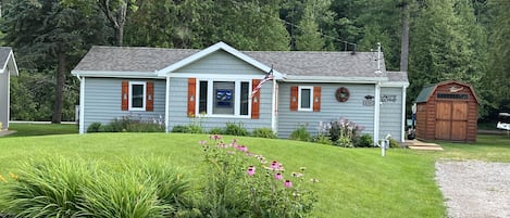 Street view of the cottage. My husband & I made the pine cut-out shutters.