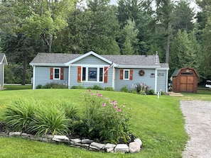 Street view of the cottage. My husband & I made the pine cut-out shutters.