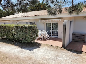 Terrasse privative avec store et salon de jardin pour 6