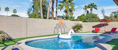 Stunning private backyard pool where you can lounge over next to palm trees